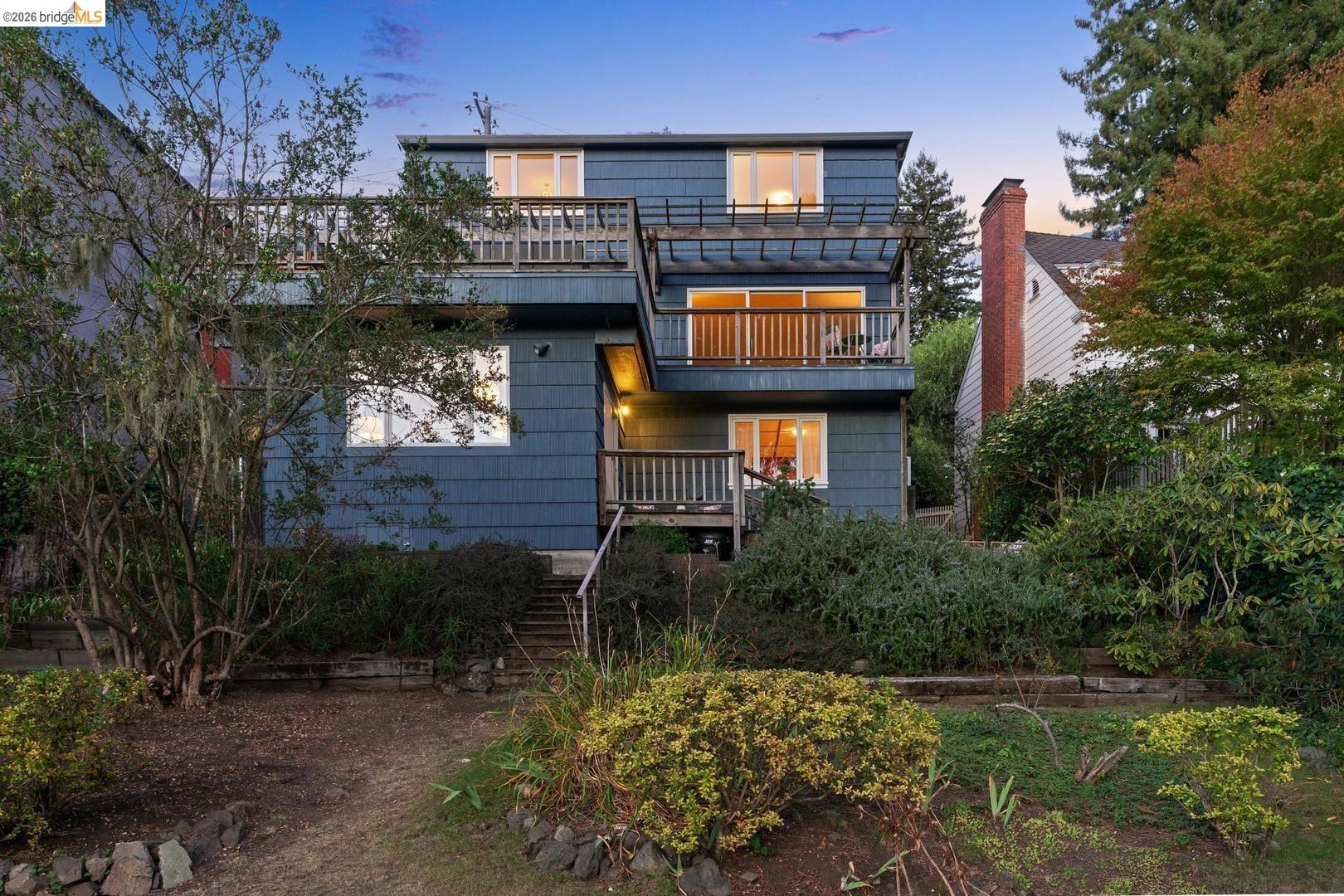 155 Avenida Drive Berkeley, CA 94708 - Photo 85 of 86 Multi-level exterior with siding, featuring two balconies with wood railings, a pergola structure, and a brick chimney