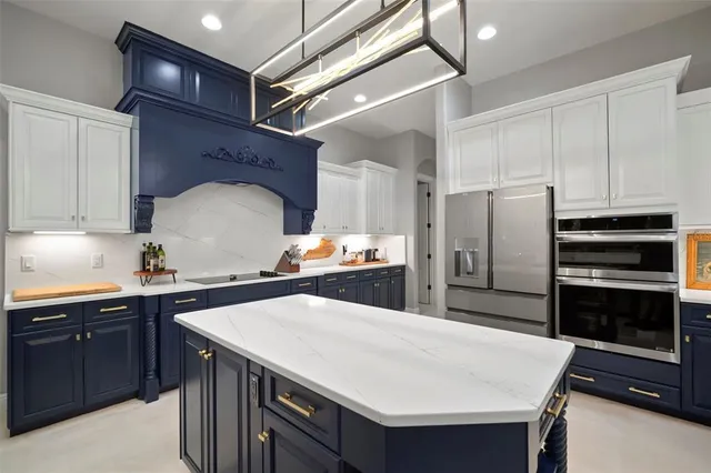 a kitchen with kitchen island a sink appliances and cabinets
