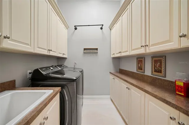 a kitchen with granite countertop a sink stove and cabinets