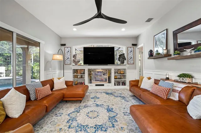a living room with fireplace furniture and a flat screen tv
