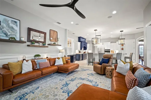 a living room with furniture kitchen view and a couch