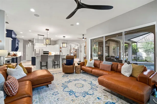 a living room with furniture ceiling fan and a rug
