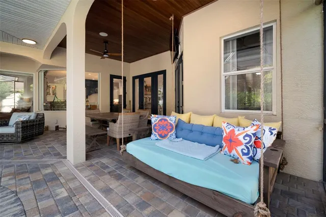 a dining room with wooden floor and large windows