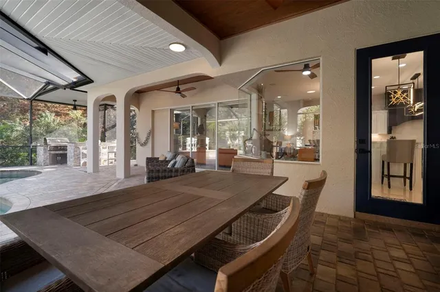 a view of a dining room with furniture large windows and wooden floor