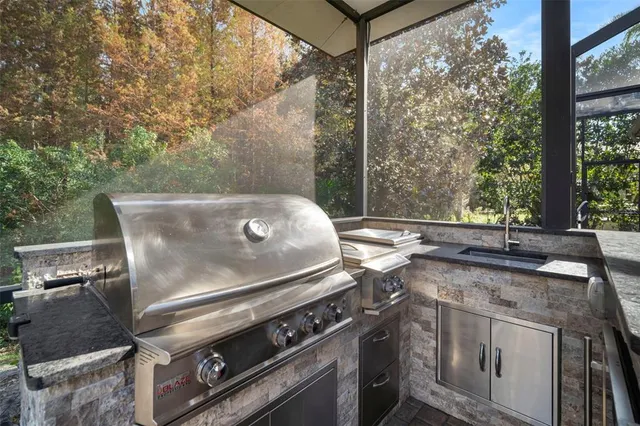 a open kitchen with a sink and chairs