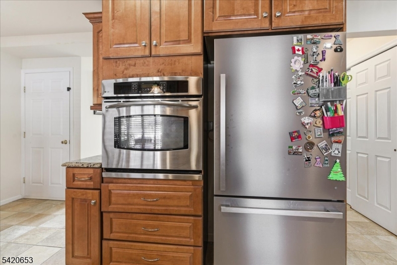 26 Eldora Road Parsippany, NJ 07054 - Photo 16 of 47 a kitchen with stainless steel appliances granite countertop a refrigerator and a stove