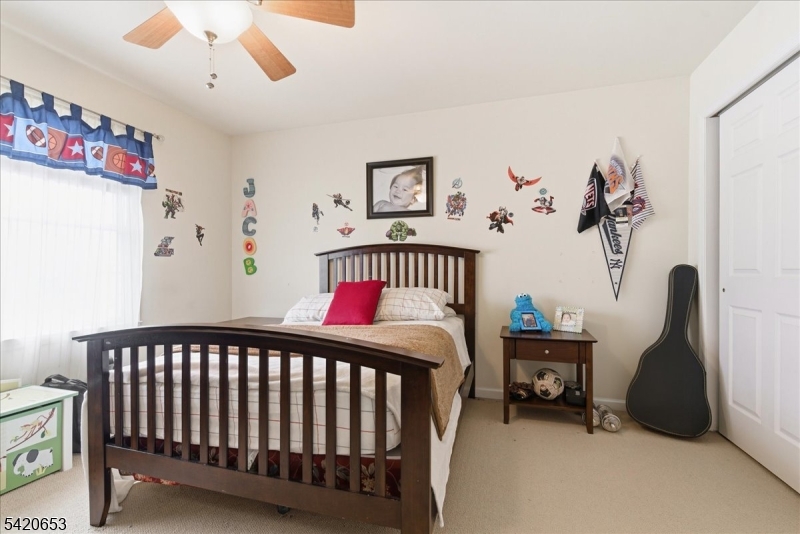 26 Eldora Road Parsippany, NJ 07054 - Photo 24 of 47 a bedroom with a bed and a chandelier