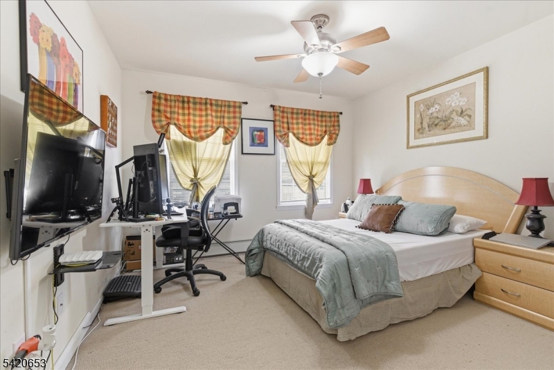 26 Eldora Road Parsippany, NJ 07054 - Photo 25 of 47 a bedroom with a bed a couch and a flat tv screen on dresser