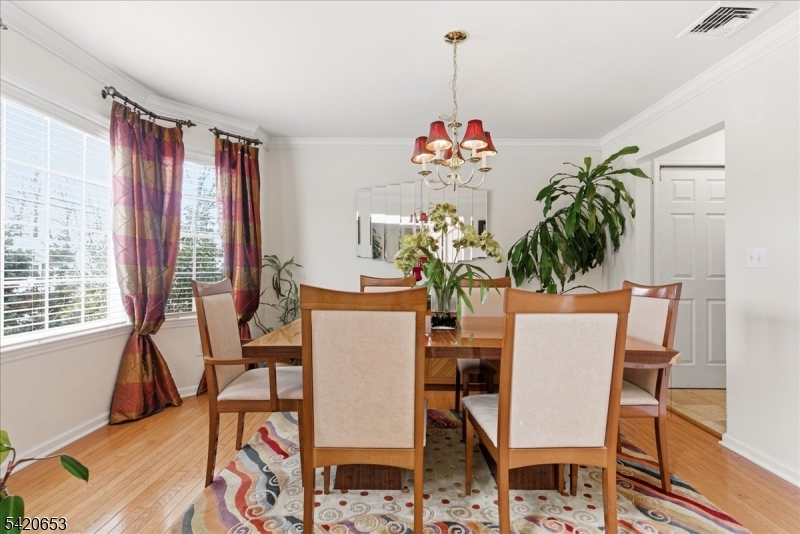 26 Eldora Road Parsippany, NJ 07054 - Photo 5 of 47 a dining room with furniture a potted plant and wooden floor