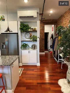 a dining room with furniture and wooden floor