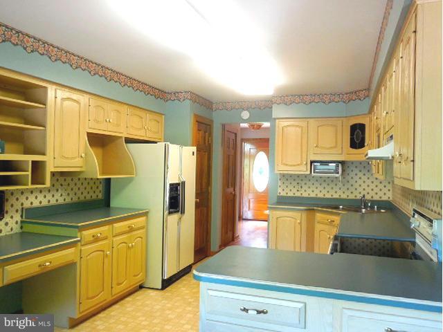 5130 Fox Tower Road Smithsburg, MD 21783 - Photo 16 of 30 a kitchen with stainless steel appliances granite countertop a sink and a refrigerator