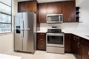 a kitchen with a refrigerator stove and microwave