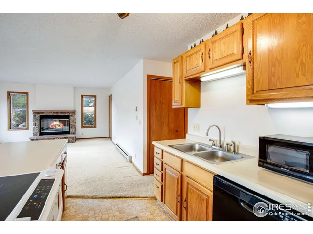 a kitchen with a stove a sink and a refrigerator