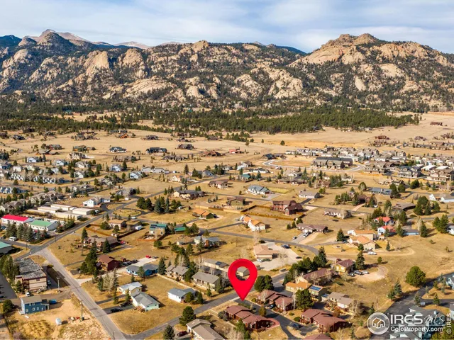 an aerial view of residential houses with city and mountain view