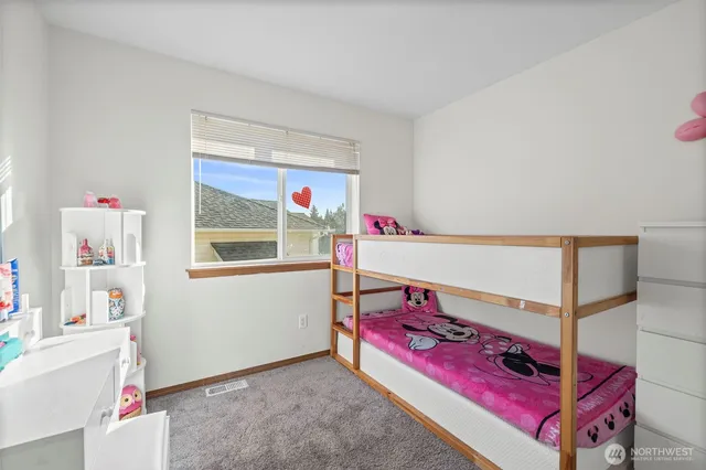 a bedroom with furniture and a lamp