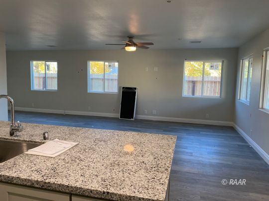 1220 Porter Street Ridgecrest, CA 93555 - Photo 5 of 6 a kitchen with a sink a mirror and wooden floor