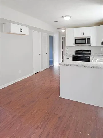 a view of kitchen with wooden floor