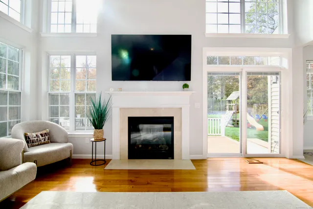 a living room with furniture a flat screen tv and a fireplace