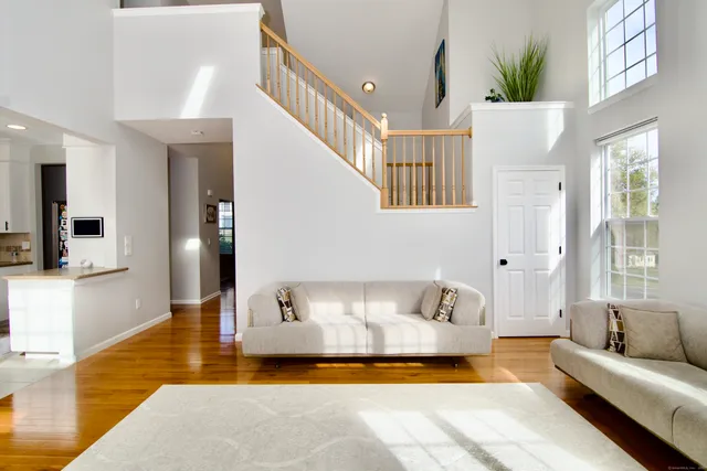 a living room with furniture and a chandelier