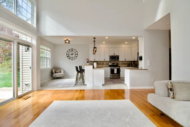 a large kitchen with stainless steel appliances granite countertop a sink and cabinets