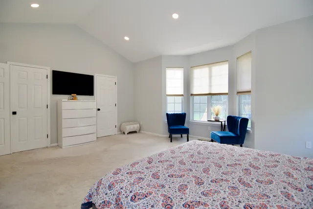 a view of a bedroom with furniture and a flat screen tv