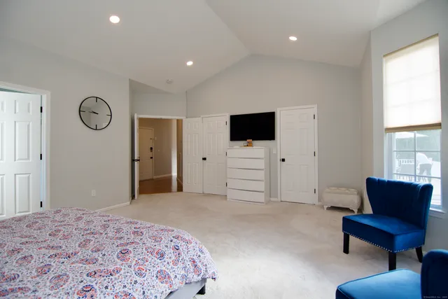 a bedroom with a bed and a television