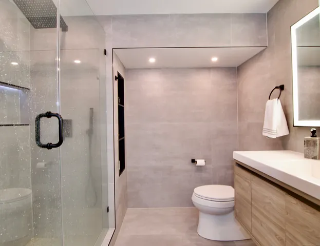 a bathroom with a toilet a sink and shower