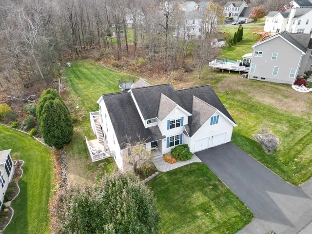 an aerial view of a house with swimming pool garden and patio