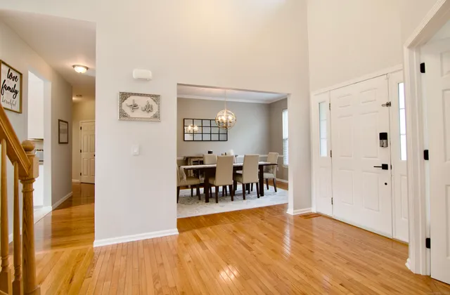 a view of a room with wooden floor and furniture