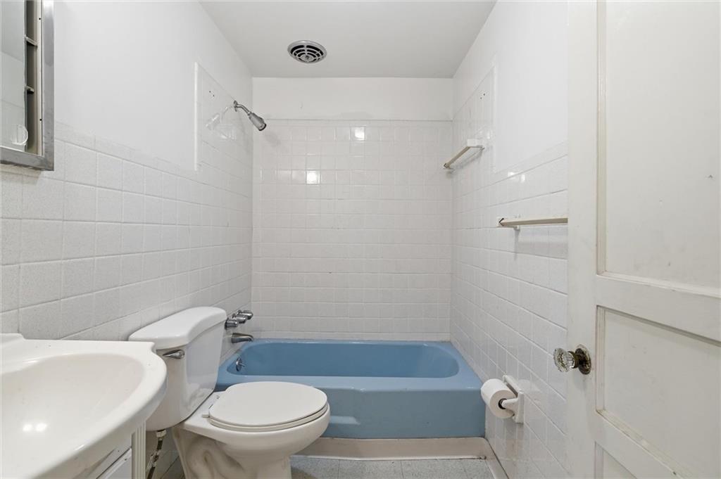 138 Enger Avenue Pittsburgh, PA 15214 - Photo 13 of 50 a white toilet sitting next to a bath tub