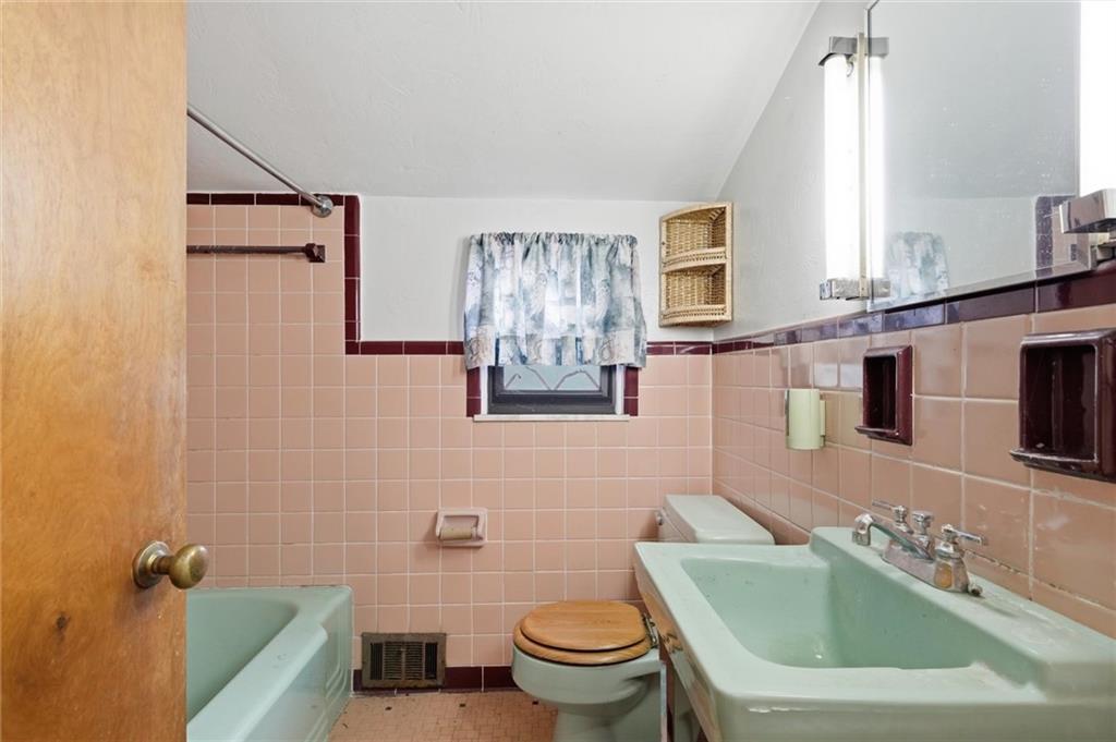 138 Enger Avenue Pittsburgh, PA 15214 - Photo 22 of 50 a bathroom with a toilet sink and mirror