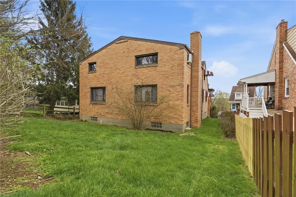 138 Enger Avenue Pittsburgh, PA 15214 - Photo 47 of 50 a brick house with a yard