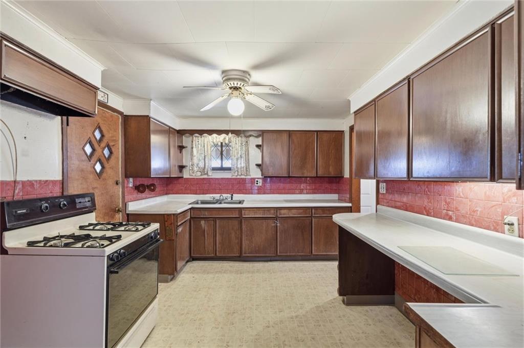138 Enger Avenue Pittsburgh, PA 15214 - Photo 7 of 50 a kitchen with stainless steel appliances granite countertop a stove and a sink