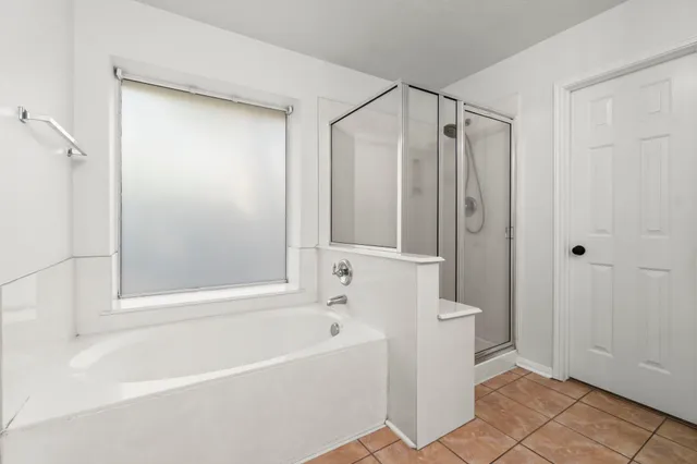 a bathroom with a bathtub and a shower