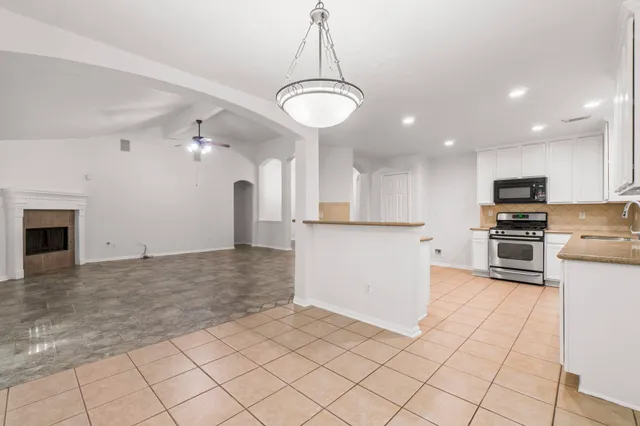 a view of a kitchen with microwave and cabinets