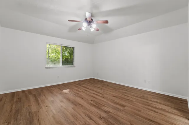 wooden floor in an empty room with a window