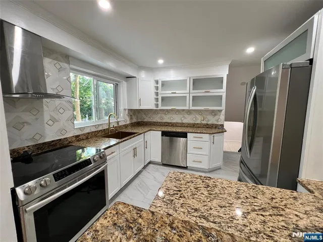 a bathroom with a sink a toilet a mirror and vanity