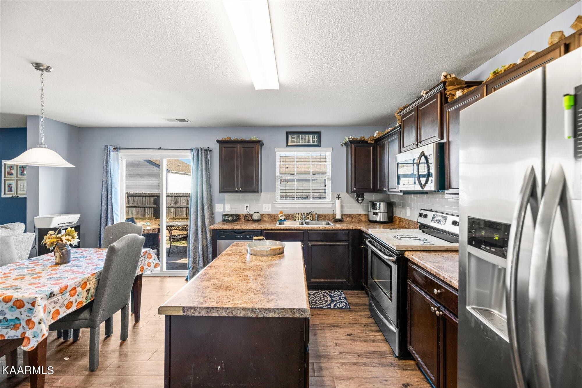 7136 Lawgiver Circle Corryton, TN 37721 - Photo 3 of 12 a large kitchen with granite countertop a large counter top appliances and cabinets