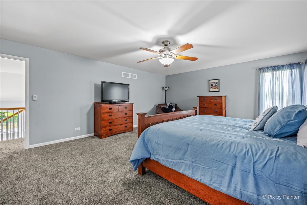 7104 Dove Way Cary, IL 60013 - Photo 27 of 82 a bedroom with a bed and a tv