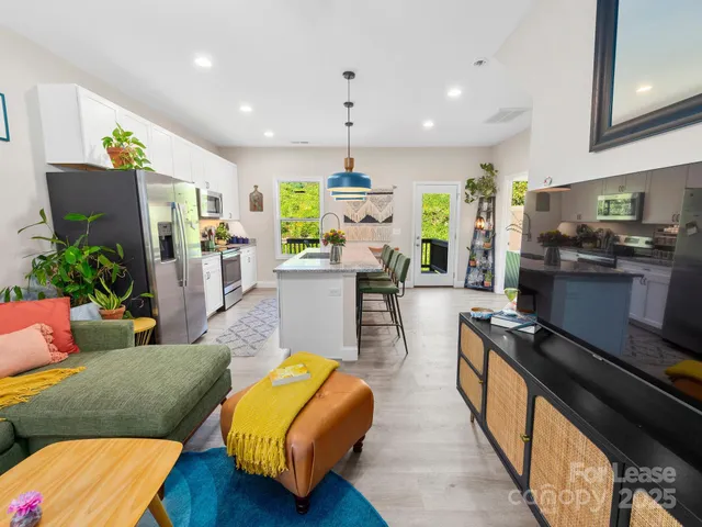 a living room with furniture and a chandelier