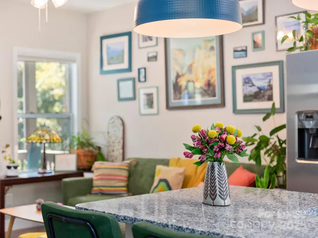 a dining room with furniture and flowers