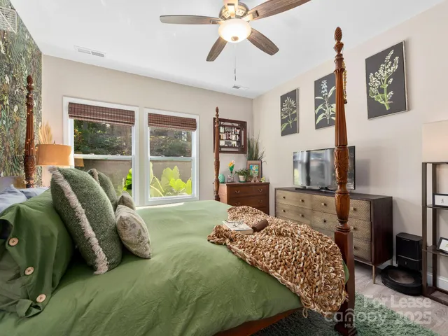 a dining room with furniture and a potted plant
