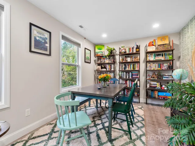 a vase of flowers sitting on a table with window