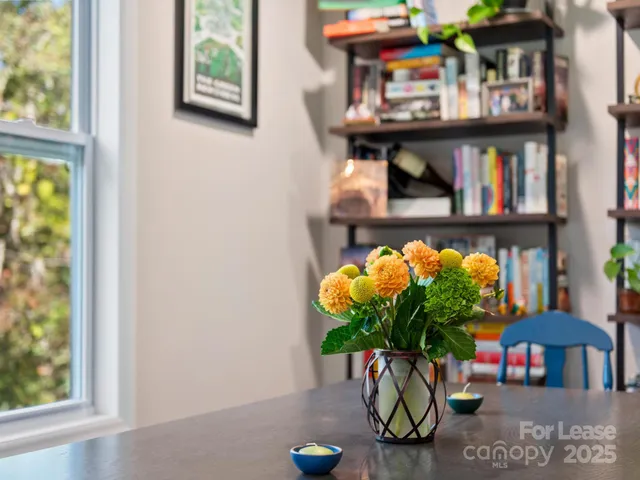 a dining room with furniture and window