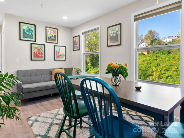 a living room with furniture a flat screen tv and a large window