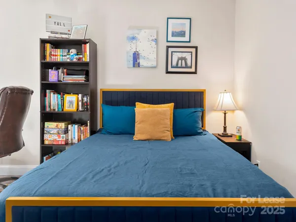 a bathroom with a granite countertop sink a toilet and a mirror
