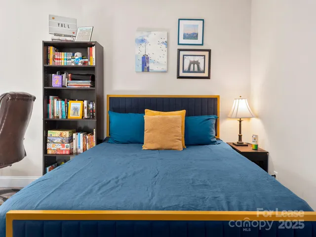a bathroom with a granite countertop sink a toilet and a mirror
