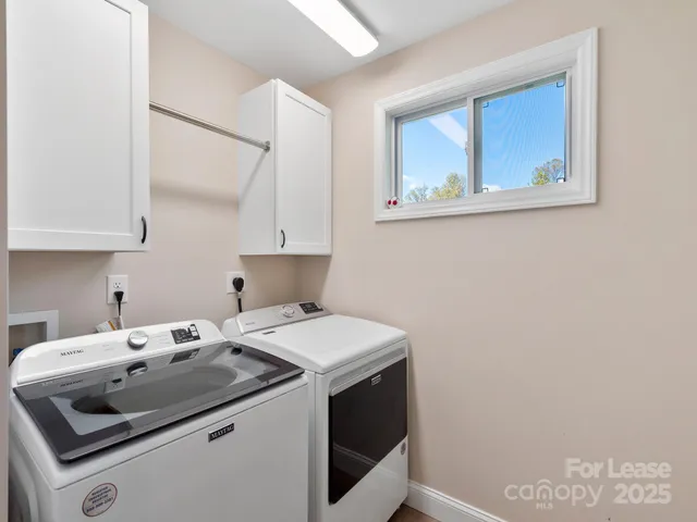 a view of a backyard with plants and chairs