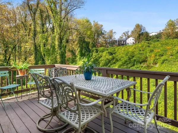 a view of a chairs and table in backyard