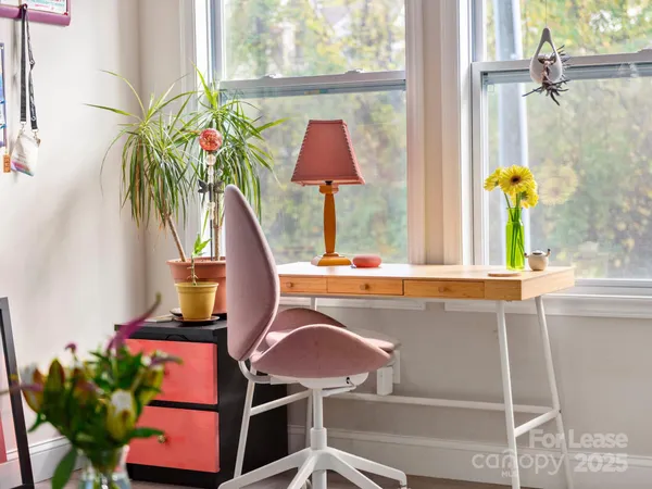 a vase of flowers sitting on a table with a window